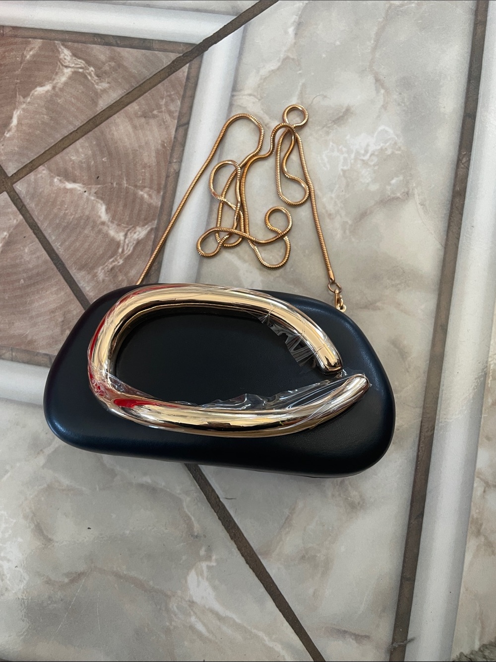 Black Clutch with Sculptural Gold Accent and Chain Strap